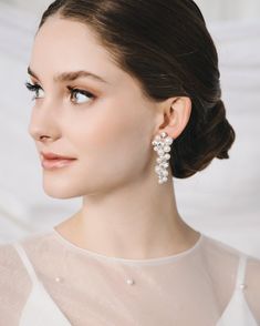 "BIANCA PEARL EARRINGS (JE-4463) Complete your bridal look with our Bianca Pearl Earrings. With a hand wired, dangle design, sparkling round crystals, and lustrous round pearls, these earrings embody elegance and sophistication. Perfect for the stylish bride seeking a touch of luxury on her special day.  DETAILS * White pearls and crystal beads * 2\" length * Hypoallergenic, lead-free & nickel-free * Style #4463 SHOP MORE STYLES https://www.etsy.com/shop/darethcolburndesigns NEED MORE HELP? Happy to offer advice or recommendations, just message me!" Wedding Earrings Pearl, Bridal Drop Earrings, Crystal Wedding Earrings, Pearl Earrings Designs, Drop Earrings Wedding, Pearl Bridal Earrings, Crystal Comb, Pearl Statement Earrings, Sparkle Design