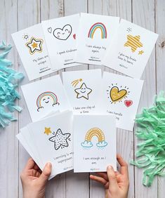 four children's handmade cards with pictures of rainbows and stars