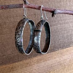 Add a touch of sophisticated Western style to your everyday look with our Prairie Hoops. These solid sterling silver hoop earrings feature a unique tooled leather texture that is both eye-catching and timeless. The medium statement size is perfect for dressing up or down, making them a versatile addition to your jewelry collection. Crafted from high-quality materials, the Prairie Hoops are built to last. The sterling silver earwire is nickel-free and hypoallergenic, so you can wear them comfortably all day long. The tooled leather texture is hand-applied, giving each pair of earrings a unique look. Whether you're dressing up for a night out or adding a touch of flair to your everyday style, the Prairie Hoops are sure to turn heads. Engraved Small Hoop Jewelry, Small Hoop Engraved Earrings, Silver Hoop Jewelry With Engraving, Silver Engraved Hoop Jewelry, Silver Engraved Small Hoop Earrings, Sterling Silver Engraved Hoop Earrings For Anniversary, Engraved Silver Hoop Jewelry, Engraved Sterling Silver Hoop Earrings For Anniversary, Modern Sterling Silver Etched Jewelry