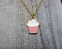 Cute cupcake necklace, with matching brass chain and closes with a lobster claw clasp. Pendant is 16mm long, 11mm wide Choose your length of chain during checkout. I package each piece of jewelry in a colorful organza bag. Perfect for gift giving or a gift for yourself. Don't forget to look through the add on section to add more customized fun. https://www.etsy.com/shop/RevelryJewelry Thank you fairy much. Sweet Nickel-free Jewelry Gift, Cute Charm Necklaces For Gifts, Sweet Nickel-free Jewelry For Gifts, Small Charm Necklace With Lobster Clasp For Gift, Handmade Gold Sweet Jewelry, Sweet Silver Necklace Perfect For Gifts, Sweet Gold Necklace For Gift, Sweet Gold Necklace As Gift, Sweet Gold Necklace Perfect For Gift