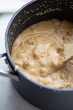 a wooden spoon stirring batter in a pot