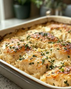 a casserole dish filled with chicken and cheese