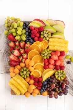 a bunch of different types of fruit on a cutting board