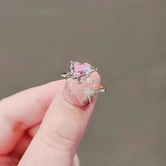 Adorable pink crystal heart golden starburst cocktail layered ring, romantic girly style, super cute yet delicate. Pastel pinky zircon with gold ribbon decorated, layered with sparkly diamond cz gold north star, absolutely eye catching. Cute sweetheart vibes, perfect birthday gift, friendship ring gift idea, or the sweetest treat for yourself! 💎 Features:♥ Material: Finest gold plated brass♥ Main stone: Pink zircon♥ Side stone: Cz crystal♥ Open adjustable band, fit US size 4-10 💎 Details:♥ App Magical Ring, Pink Heart Rings, Pink Zircon, Romantic Rings, Gold Heart Ring, Dainty Gold Rings, Princess Ring, Heart Shaped Rings, Rhinestone Ring