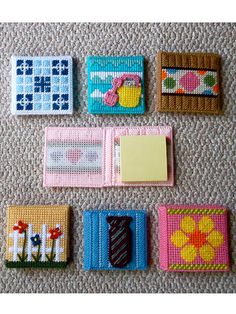 several different types of small cards on a carpeted floor with one card holder in the middle