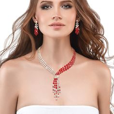 This exquisite set, draped in radiant yellow gold, exudes a timeless charm, while the sparkling Diamondeau®, flawless simulated diamond, adds a touch of sophistication and glamour. At the heart of this ensemble is a necklace that elegantly flows around the neck, reminiscent of a graceful tie, yet imbued with a sense of femininity and grace. The red and white gems create a mesmerizing contrast that captivates the eye and commands attention. Completing the set are the matching earrings. Each earri Luxury Red Faceted Jewelry, Elegant Red Faceted Necklace, Elegant 14k Gold-filled Red Jewelry, Formal Red Medallion-shaped Jewelry, Luxury Red Faceted Beaded Necklace, Gowns Of Elegance, Matching Earrings, Diamond Necklace, Red And White