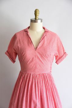 "Vintage 1950s cotton daydress. Red / white gingham print. V collar with embroidered x, capped fold over sleeves, and nipped waist. Hem of full skirt has black embroidered swans. Side metal zipper closure. State of garment | good, small (poor) mend under arm, will need reinforcement. faint yellowing on side of the skirt. refer to photos & request further photos if needed. selling as is. Measurements ✂--- best fit | small / medium bust | 35\" shoulders | not specified shoulder to waist | 15.5 Retro Cotton Dress For Picnic, 1950s Style Cotton Dresses With Short Sleeves, Retro Cotton Vintage Dress For Picnic, Lined Cotton Vintage Short Sleeve Dress, 1950s Style Cotton Vintage Dress With Short Sleeves, 1950s Style Vintage Cotton Dress With Short Sleeves, 1950s Style Short Sleeve Cotton Vintage Dress, 1950s Style Short Sleeve Cotton Dress, Retro Gingham Vintage Dress In Cotton