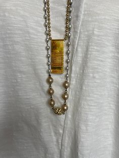 With a two-strand necklace that features one strand of glass beads and pearls and another showcasing a vintage 1940's money clip, this jewelry piece is sure to capture attention. Create a timeless look with this beautiful keepsake. Length: 30" - 39" Vintage Rectangular Necklaces For Formal Occasions, Vintage Beaded Chain Jewelry As Gift, Vintage Rectangular Formal Necklaces, Vintage Double Strand Necklaces For Formal Occasions, Vintage Beaded Chain Necklace For Formal Occasions, Classic Gold Jewelry For Vintage Collection, Vintage Jewelry With Rectangular Pendant For Formal Occasions, Vintage Double Strand Jewelry For Formal Occasions, Vintage Formal Beaded Chain Necklace