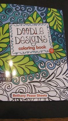 a coloring book with the title doodle designs coloring book written in orange and blue