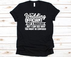 a black t - shirt that says i'm a wedding officiant not a magician but i can see why you might be confused