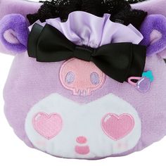 a purple and black stuffed animal with a bow on it's head is shown