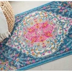 a blue rug with pink and yellow flowers on it