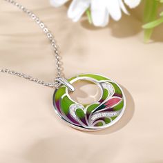 Add a pop of color to your look with the flower enamel necklace. An unusual silver necklace finished with a pendant of mixed coloured enamel circle set in a flower design. A tonal combination of colours make this a very versatile necklace to wear with lots of different outfits.Carat Weight: 0.225 ctStone Size: 1,1.2 mmNumber of Stones: 17 Stone Shape: RoundStone Color: Diamond WhiteWeight: 4.93 gWidth: 25 mmHeight: 28.8 mmThickness: 5.3 mmMaterial: 925 SilverStone Type: Jeulia® StonePlating Colo Multicolor Enamel Pendant Necklaces, Multicolor Enamel Pendant Necklace, Multicolor Enamel Round Pendant Necklace, Enamel Round Pendant Necklace, White Gold Enamel Round Pendant Necklace, White Gold Enamel Necklaces, Green Enamel Round Pendant Jewelry, Dreamy Garden, Enamel Necklaces