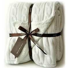 two white blankets wrapped in brown ribbon