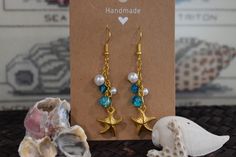 These beachy dangle earrings are handmade and hand assembled with beachy vibes in mind!  The material is delicate and should not be worn in water or with oils and lotions! Adjustable Gold Beaded Earrings For Beach, Handmade Ocean Color Jewelry For Summer, Handmade Ocean Color Summer Jewelry, Turquoise Nickel-free Beaded Earrings For Beach, Turquoise Beaded Beach Earrings, Summer Beach Jewelry Wire Wrapped, Summer Beach Wire Wrapped Jewelry, Nickel Free Starfish Jewelry For Summer, Handmade Beaded Earrings For Beach