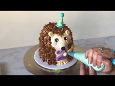 a birthday cake with a hedgehog on top and a blow dryer in the foreground