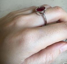 "A Classic oval shaped Faceted Lab Created Ruby Sterling Silver Ring featuring a comfort fit band with a bezel around the stone. This makes a great birthstone ring for those July Birthdays! Wrapped in a box ready for gift giving.(r-537) RING INFO ---------------- STERLING SILVER Stone with Bezel measure 11.5mm x 10mm July BIRTHSTONE *Follow us @belesasjewelry on Instagram for promotions/giveaways *LIKE* us on Facebook http://www.facebook.com/Belesas *If you like the ring, please click on the \"P Star Labs, Red Rings, Faceted Ring, Bezel Ring, Red Gemstones, July Birthstone, Rings Simple, Ruby Ring, Birthstone Ring