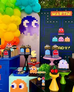 an image of a birthday party with pacman decorations and games on the wall in the background