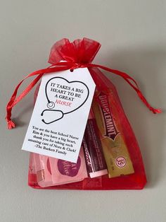 an organ bag filled with personal care items and a red ribbon tied around the package