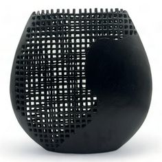 a black vase with holes in it on a white background, that is shaped like a half circle