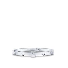 Cast in 18-kt white gold, the empreinte unisex bangle features nail-head imprints, a nod to the house’s trunk-making heritage. The lv initials motif adds a bold signature touch and also serves as a clasp for this hinged bracelet. Available in several sizes, this modern jewel can be worn solo or stacked with other pieces for an on-point look. Luxury White Gold Engraved Cuff Bracelet, Luxury Engraved White Gold Cuff Bracelet, Designer White Gold Bangle For Anniversary, Designer White Gold Bangle, Designer White Gold Bangle With Jubilee Bracelet, Designer Engraved White Gold Bracelets, Timeless Jewelry With Palladium Hardware For Everyday Luxury, Timeless Platinum Jewelry With Palladium Hardware, Timeless White Gold Jewelry With Palladium Hardware