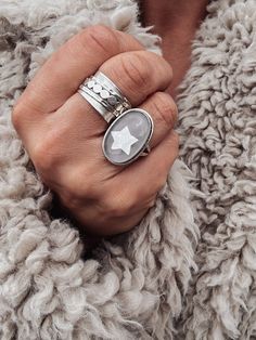 A truly unique statement ring featuring a glittering star skilfully hand carved from iridescent, mother of pearl, captured inside a quartz dome. The quartz overlay is is predominantly clear with characteristic inclusions and shadows giving the effect of a misty night sky with the star beneath shimmering through. Set in 925 sterling silver. ▪️.925 sterling silver ▪️Hand-carved mother of pearl ▪️Clear Quartz ▪️30mm x 20mm ▪️Various sizes available ▪️The ring will be presented in Scraffs gift packa Misty Night, Crystal Ring, Quartz Ring, Jewelry Companies, Crystal Rings, Ring Sterling Silver, Clear Quartz, Statement Ring, Rings Statement