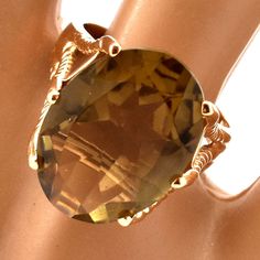 Exquisite 14 karat solid yellow gold ring set to the front with one large oval-cut smoky quartz measuring approximately 18 millimeters long by 13 millimeters wide and weighing an estimated 10.56 carats. The ring is a size 6 1/2 and can be re-sized to fit by your local jeweler. It is stamped 14K and signed AJ. It weighs approximately 6.23 grams. Excellent estate condition. We are listing several pieces of estate jewelry, along with other items fresh from fine North Carolina estates. We are happy Gold Oval Ring With Large Stone, Yellow Gold Oval Jewelry With Large Stone, Oval Diamond Cut Rings For Collectors, Collectible Oval Gold Rings, 14k Gold Jewelry With Large Oval Stone, Heirloom Oval Faceted Ring, Oval Gold Faceted Rings, Oval Faceted Heirloom Jewelry, Faceted Oval Heirloom Jewelry