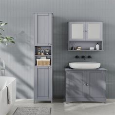 a bathroom with a sink, cabinet and bathtub