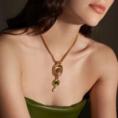 The Finian Necklace from our Lucresia Collection is truly stunning. This gorgeous necklace is made from 24K gold electroplated brass with green and purple Czech glass stones and a Majorcan glass pearl drop. It fastens with a lobster claw closure and has a 2" extender chain. The necklace measures 15.5" in length. Made to order in our New York City design studio; please allow 7-14 business days for production before the ship date. Fall Necklaces, Summer Accessories Jewelry, Formal Necklace, Vintage Statement Jewelry, Chunky Gold Necklaces, Trends 2025, Prom Inspiration, Necklace Stack, Large Pendant Necklace