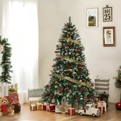 a decorated christmas tree in a living room with presents on the floor next to it