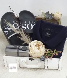 an open suitcase with shoes and flowers on it