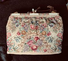 Gorgeous vintage tapestry shoulder bag by Morabito, Paris. The clasp has mother of pearl on a gold tone frame.  The shoulder strap is gold tone chain.  Light salmon tone satin lining in great condition. Three pockets inside.  This vintage bag is wonderful for a special event.   Hapy to answer questions about this item Please note that my store doesn't accept returns and doesn't ship internationally. Vintage Beige Shoulder Bag For Evening, Vintage Tapestry Shoulder Bag For Evening, Vintage Beige Tapestry Bag, Vintage Tapestry Pouch Bag, Antique Tapestry Evening Bag, Vintage Tapestry Multicolor Shoulder Bag, Vintage Evening Bag With Gold-tone Hardware, Light Salmon, Vintage Tapestry