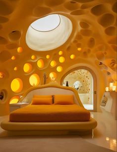 an orange bed sitting in the middle of a room next to a ceiling with circles on it