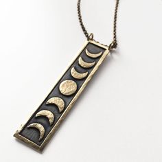 Crescent Moon Phase Brass Jewelry, Mystical Sun And Moon Brass Jewelry, Celestial Moon-shaped Jewelry For Meditation, Mystical Brass Jewelry With Sun And Moon Design, Celestial Moon Jewelry For Meditation, Symbolic Metal Necklace With Moon Phase Detail, Celestial Moon Phase Brass Necklace, Celestial Metal Moon Phase Necklace, Celestial Brass Moon Phase Necklace