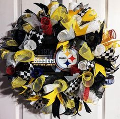 a wreath made out of yellow, black and white mesh with the pittsburgh football logo on it