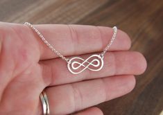 Double infinity necklace in sterling silver, sterling silver necklace, infinity symbol, eternity necklace, friendship necklace, mother's day A sterling silver double infinity symbol link that measures 0.91 x 0.39 inches (23 x 10mm) is attached to a sterling silver chain that can be any length up to 22 inches. It is secured with a sterling silver spring ring clasp. Your purchase will arrive in a jewelry box ready for gift giving or as a gift for yourself! Enter my shop here: jersey608jewelry.etsy Sterling Silver Infinity Necklace With Adjustable Chain, Silver Infinity Dainty Necklace, Silver Infinity Necklace In Dainty Style, Sterling Silver Infinity Necklace In White Gold, Silver Dainty Infinity Necklace, Silver Infinity Jewelry, Infinity Jewelry As A Gift For Mom, Silver Infinity Jewelry For Anniversary, Dainty Silver Infinity Necklace