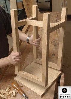 a man is working on a wooden object in the process of making it look like he's trying to build something out of wood