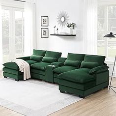 a living room with white walls and green furniture