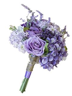 a bridal bouquet with purple flowers and greenery