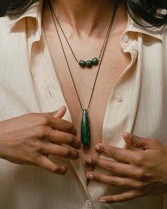 MONIKH DALE x DAPHINE A striking Jade stone teardrop-shaped pendant is at the heart of the Dhari Necklace. Meticulously polished to reveal its unique natural lines and rich green hues, each pendant is one-of-a-kind, ensuring that no two stones are alike. The stone hangs from a long rope which can be adjusted to your desired length. We love it stacked with the Dale Necklace for the perfect summer look. Necklaces For Summer, Monikh Dale, Jewellery Styling, Cord Necklaces, Summer Jewellery, Red Tourmaline, Long Rope, Natural Line, Gold Plated Bangles