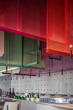 the interior of a restaurant with red and green lights hanging from the ceiling over the counter