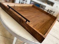 a wooden tray sitting on top of a white table