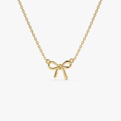 Discover the charm of our 14K Solid Gold Bow Ribbon Necklace, a minimalist design that symbolizes the tying of a knot. This elegant piece is perfect for bridesmaids, maids of honor, or your best friend, reflecting a bond of friendship and gratitude. Its sleek and simple bow design makes it an ideal birthday gift, offering a subtle yet beautiful addition to any jewelry collection. A thoughtful and stylish choice, this necklace serves as a memorable token for those closest to you. ▶ Details   * Made to Order  * Gold KT: 14K Solid Gold (also available in 18K & Platinum upon request)  * Length & Width: 10 x 7.75 MM * Ready to Ship in 1-2 Business Days ▶ See more of our Gold Necklaces - http://etsy.me/2lUxj86  ▶ See our storefront here - http://etsy.me/2lUcVnH  ▶ All store sections here  Diamon Gold Necklace With Bow For Gifts, Elegant Gold Necklace With Bow, Gold Dainty Bow Jewelry, Gold Bow Necklace, Elegant Bow Pendant Necklace, Ribbon Necklace, Bow Necklace, Gold Armband, Ruby Jewelry