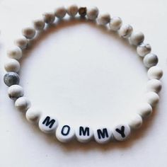 For all the mommies + daddies out there. You know who you are. One for you, one for bae.Perfect gift for new parents or pros! The mommy bracelet is cool grey and white howlite with white letters. The daddy bracelet is black lava rock with black letters. So fun to wear as a couple 🖤Set includes one mommy bracelet in 7” diameter women’s size and one daddy bracelet in 8.5” diameter mens size.Handmade with love. Meaningful White Jewelry With Letter Beads, Meaningful White Adjustable Beaded Bracelets, Meaningful White Beaded Hypoallergenic Bracelets, Inspirational White Bracelet With 8mm Beads, Meaningful White Hypoallergenic Beaded Bracelets, Meaningful Hypoallergenic White Bracelets, Everyday Beaded Bracelets For Mother's Day, Meaningful Adjustable White Name Bracelet, White Inspirational Stretch Bracelet With 8mm Beads