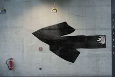 a wall with a large black arrow painted on it