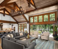 a living room filled with furniture and lots of windows