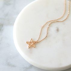 "Beautiful and lovely rose gold pentagram little star charm necklace. Made of rose gold plated tiny pentagram star charm with skinny rose gold chain. Soft and warm looking dainty necklace is good for yourself or gift ! Your necklace will ship in a rudiana gift box. * Rose Gold Plated over Brass * Necklace Length 15\"-20\" * Star Charm 1/2\" * Creation Time : 1 - 3 days * US shipping transit time : 3-5days * International shipping normally takes 7-14days ♥ See more Rudiana Accessories Rudiana.ets Minimalist Star Charm Necklace As Gift, Minimalist Star Charm Necklace For Gift, Gift Delicate Chain Necklace With Star Of David Pendant, Dainty Star-shaped Rose Gold Jewelry, Dainty Rose Gold Jewelry With Star Charm, Dainty Rose Gold Star Jewelry, Rose Gold Star Charm Pendant Necklace, Minimalist Star-shaped Necklace As Gift, Delicate Star Of David Necklace For Gift