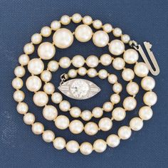 What a wonderful addition to any jewelry suite this timeless pearl and diamond necklace would make. Elegant and beautiful, we see her being worn with a simple tee-shirt, as well as evening wear. The Akoya pealrs have that rich, creamy ivory color. The diamond clasp is the star of the show, set with a beautiful old European cut diamond in a navette form. Measures 16' in length. 1.41ct center is estimated to be L/M color & VS2 clarity. Surrounding diamonds are estimated to be G/H colors & VVS/VS1 Wedding Diamond Single Strand Pearl Necklace, Wedding Diamond Pearl Necklace Single Strand, Wedding Single Strand Diamond Pearl Necklace, Diamond Pearl Necklace For Wedding, Pearl Necklace For Anniversary, Classic Single Strand Pearl Necklace For Evening, Classic Wedding Diamond Necklace With Pearl Chain, Classic Diamond Necklace With Pearl Chain For Weddings, Classic Akoya Pearl Necklace For Evening