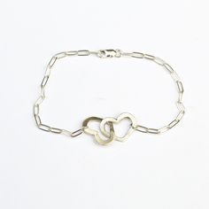 "Your heart and my heart are very very old friends" - Hafez This bracelet has 2 cutout hearts linked together on a petite clip chain bracelet. Linked hearts symbolize love for yourself, the world, another person. It is the perfect gift for a friend, loved one, or romantic partner. Bracelet measures 7 1/4" at longest length and may be clasped shorter at any link --Retail purchases are shipped in a custom Chocolate and Steel card and a jewelry box perfect for gift giving and storing your jewelry. Sterling Silver Double Heart Bracelet, Sterling Silver Double Heart Bracelet Gift, Sterling Silver Link Bracelet For Anniversary, Personalized Sterling Silver Heart Friendship Bracelet, Sterling Silver Double Heart Bracelets, Sterling Silver Heart Bracelet With Adjustable Chain For Anniversary, Hypoallergenic Sterling Silver Heart Bracelet For Friendship, Sterling Silver Heart Charm Bracelet For Friendship, Sterling Silver Friendship Bracelets For Valentine's Day