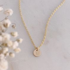 "A dainty little 14k Gold Filled initial disc is hand stamped with your choice of initial in uppercase block font. The disc measures 8mm (1/4\").  The initial disc comes on a delicate, but very strong, 14k Gold Filled chain. Beautifully packaged in our signature white and gold Eden Zoe gift box." Minimalist 14k Gold Hand Stamped Charm Necklace, Dainty Hand Stamped 14k Gold Charm Necklaces, Dainty Hand Stamped 14k Gold Necklace, Minimalist Hand Stamped Initial Necklace, Minimalist Hand Stamped Initial Necklace For Everyday, Minimalist Everyday Hand Stamped Initial Necklace, Minimalist Round Disc Initial Necklace As Gift, Minimalist Personalized 14k Gold Filled Charm Necklaces, Minimalist Round Disc Initial Necklace For Gift